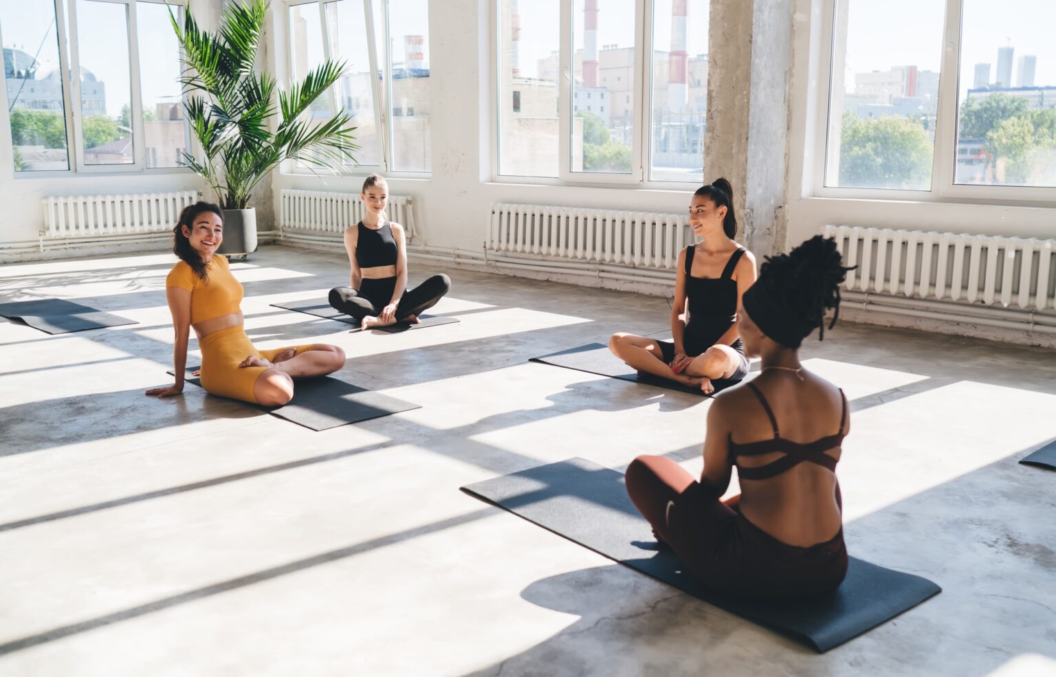 Group of multiracial women relaxing together at gym